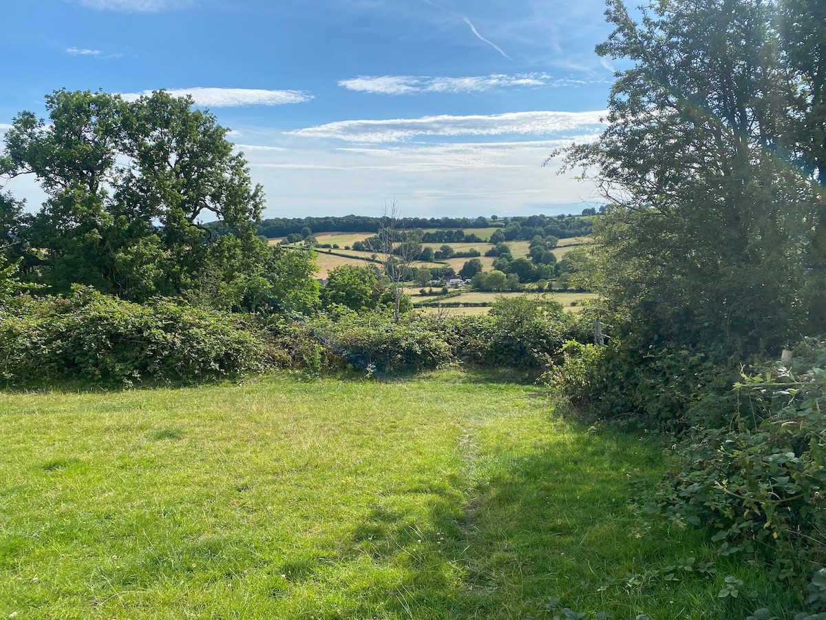 Green Derbyshire countryside and far-reaching valley views near the cabin