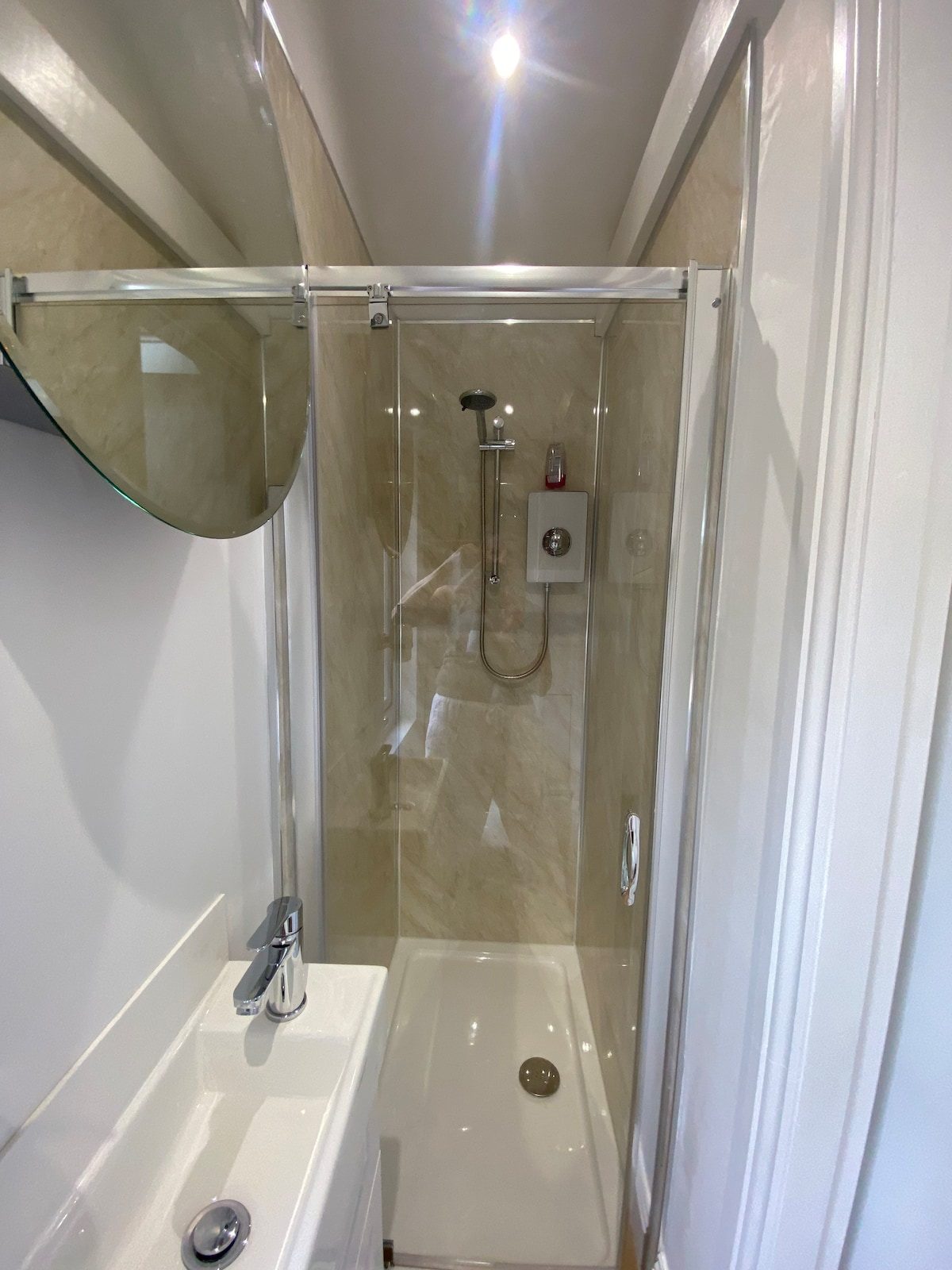 Walk-in shower enclosure with marble-effect tiling